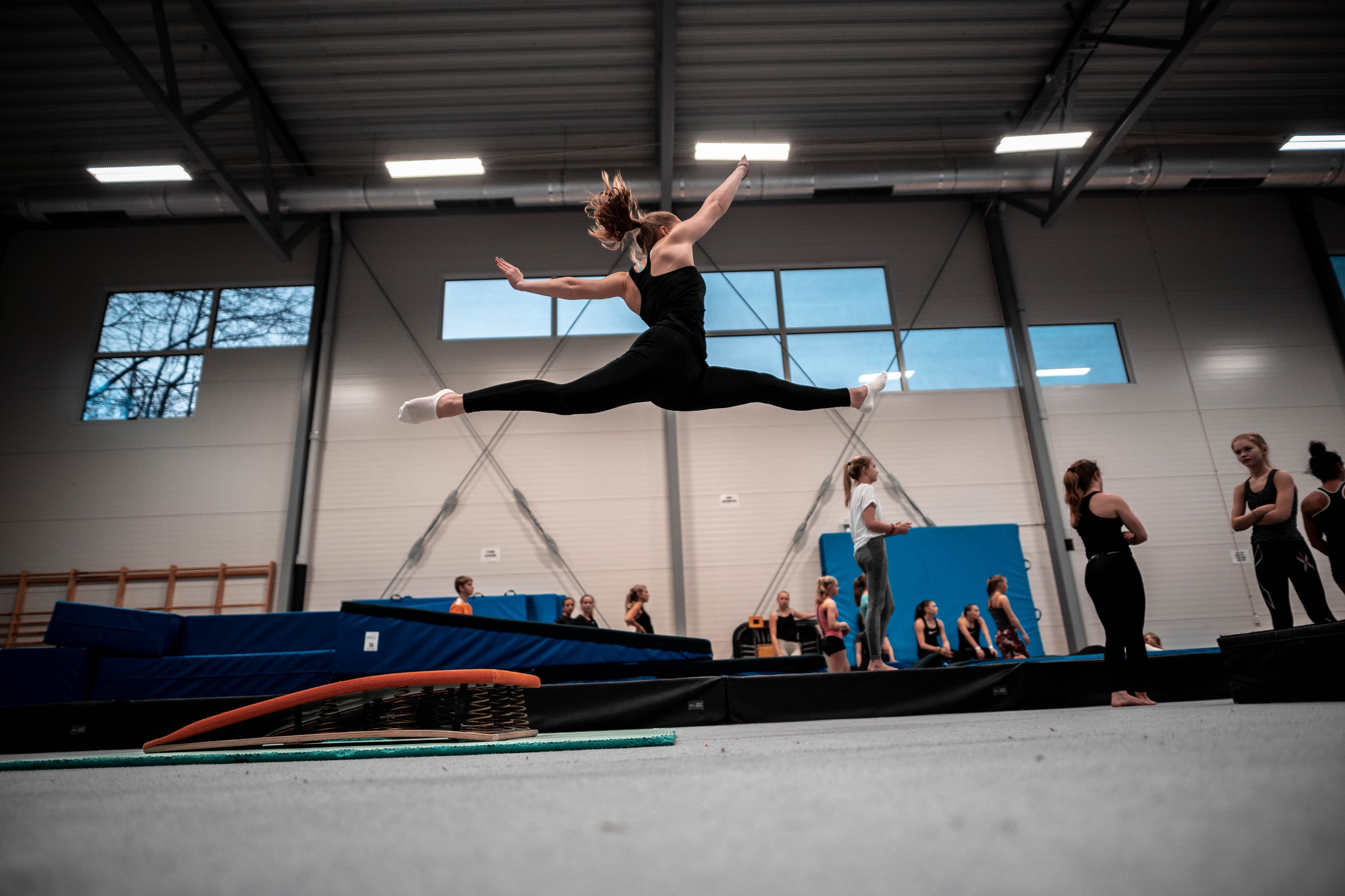TeamGym athlete in flight during training