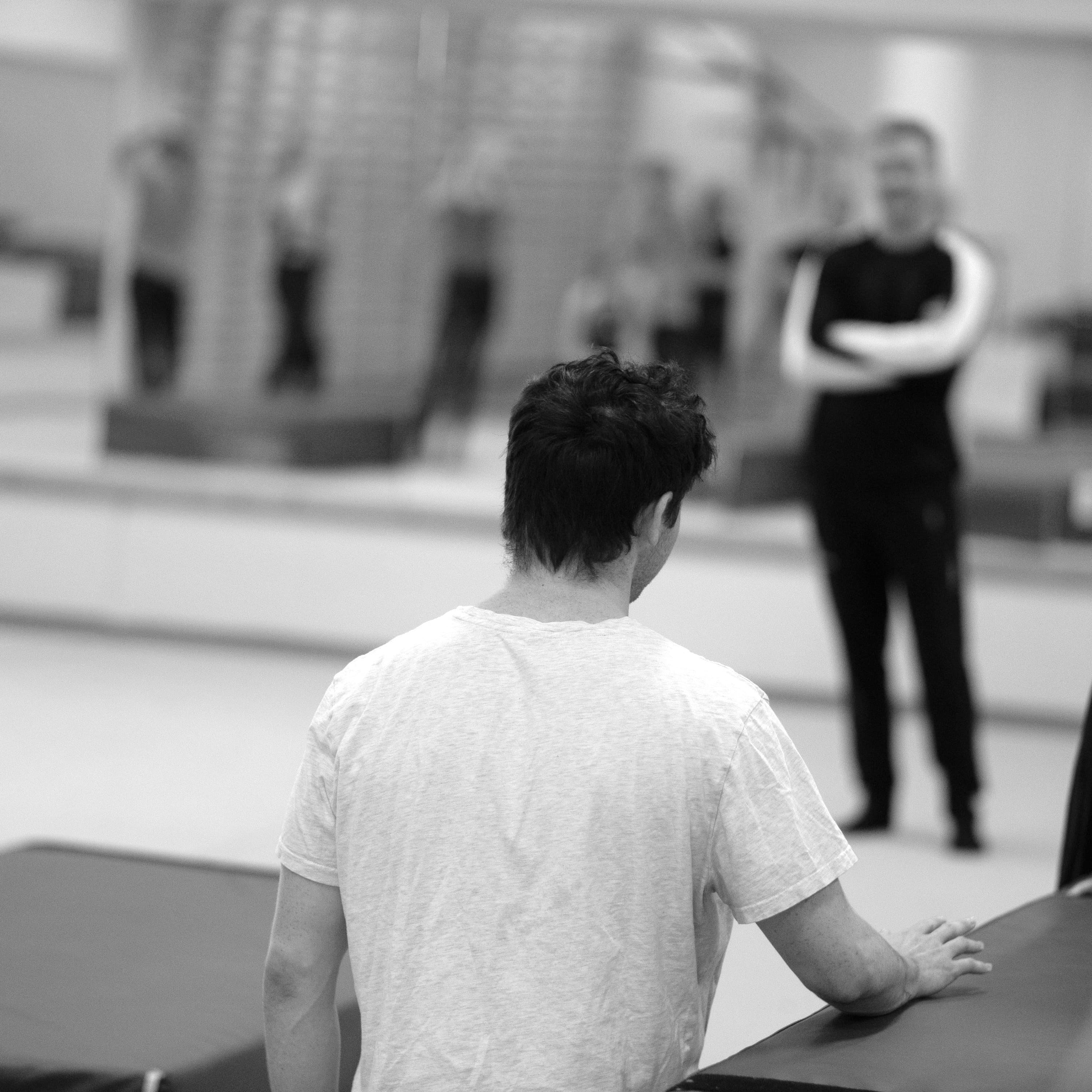 Coach supporting focused gymnast development